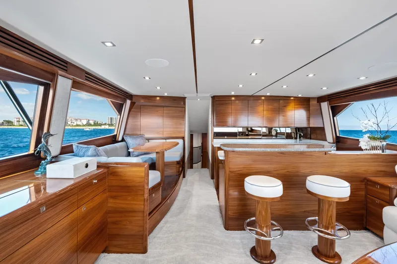 Slide: The Image of Luxurious interior of 2025 Viking 64 Convertible yacht with elegant wood finishes and ocean view. - 22
