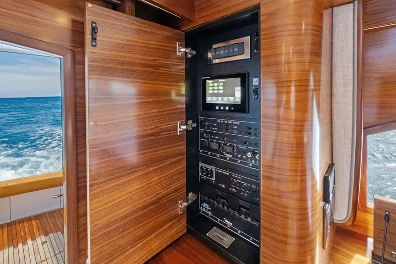 Slide: The Image of Electrical panel inside 2025 Viking 64 Convertible yacht with ocean view. - 24