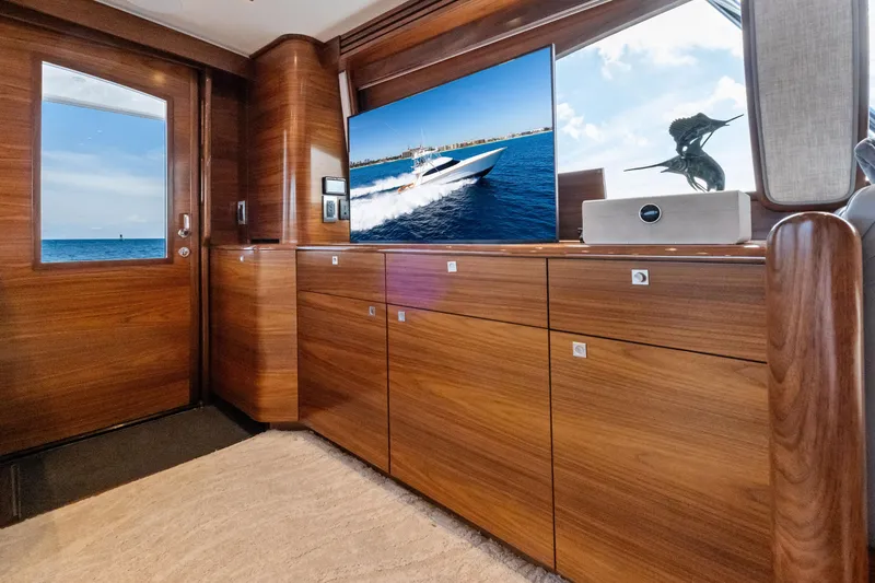 Slide: The Image of Luxurious interior of 2025 Viking 64 Convertible yacht with wooden cabinetry and ocean view. - 25