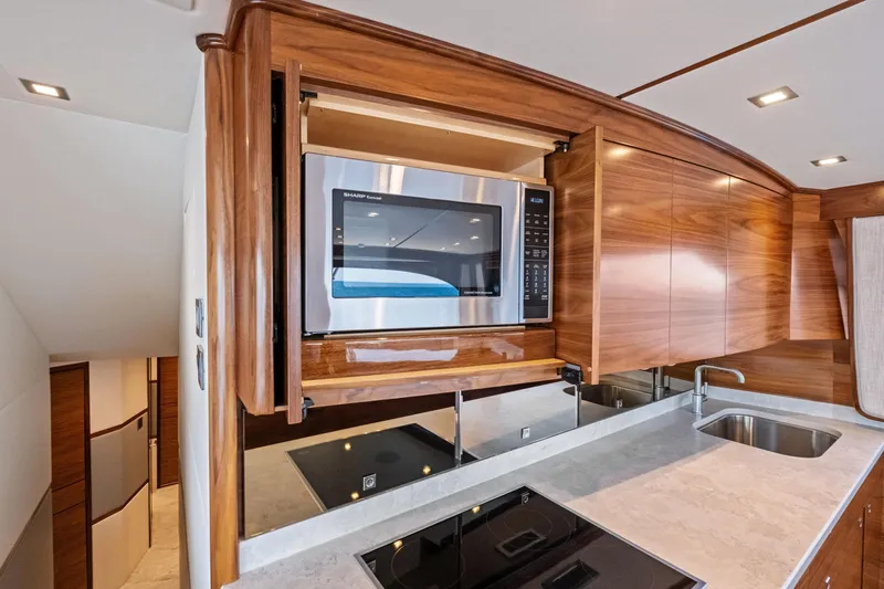 Slide: The Image of Modern kitchen in 2025 Viking 64 Convertible yacht with microwave and sleek cabinetry. - 27