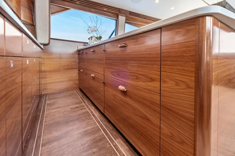 Slide: The Image of Luxurious wooden cabinetry inside the 2025 Viking 64 Convertible yacht. - 28