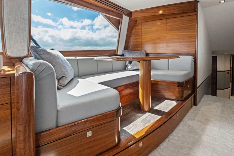 Slide: The Image of Luxurious interior of 2025 Viking 64 Convertible yacht with elegant wood finish and plush seating. - 29