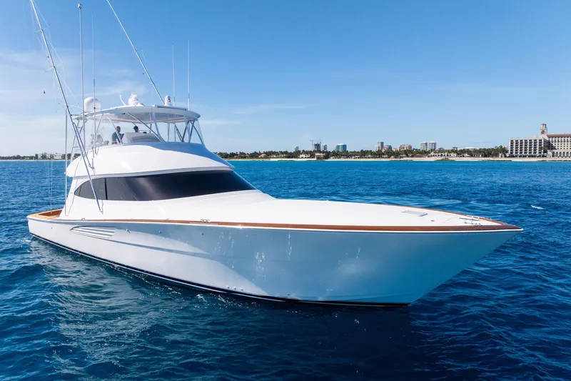 Slide: The Image of 2025 Viking 64 Convertible yacht cruising on clear blue ocean waters. - 3