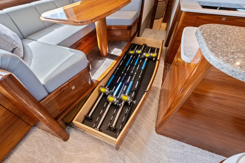 Slide: The Image of 2025 Viking 64 Convertible yacht interior with fishing rod storage drawer. - 30
