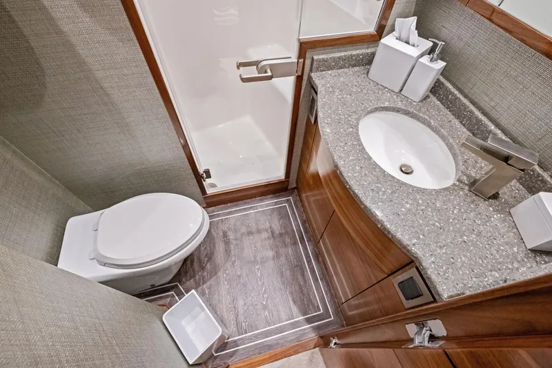 Slide: The Image of Luxurious bathroom in 2025 Viking 64 Convertible yacht with modern fixtures and elegant design. - 32
