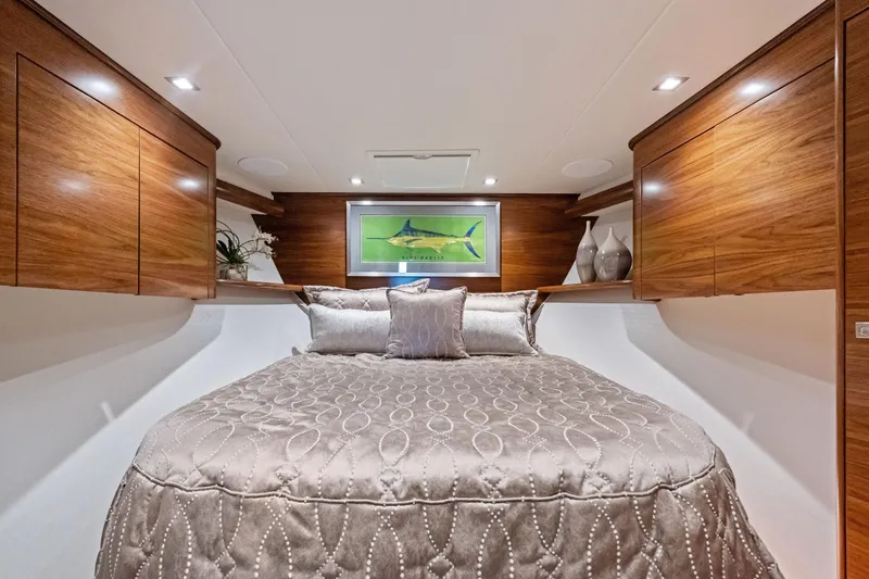 Slide: The Image of Luxurious 2025 Viking 64 Convertible yacht bedroom with elegant wood cabinetry and plush bedding. - 38