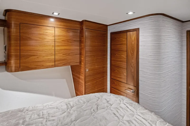 Slide: The Image of Luxurious wood interior of 2025 Viking 64 Convertible yacht bedroom. - 40