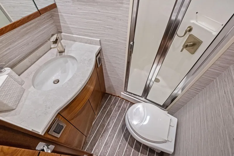 Slide: The Image of Luxurious bathroom in 2025 Viking 64 Convertible yacht with modern fixtures and elegant design. - 41