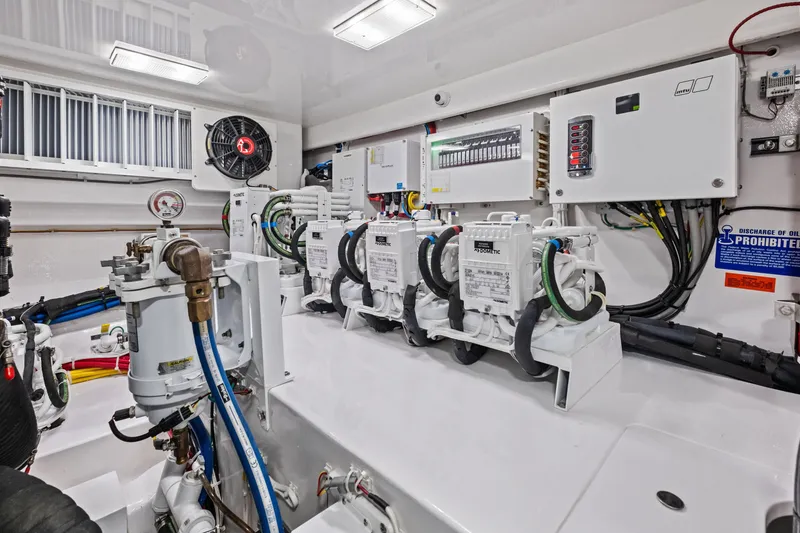 Slide: The Image of Engine room of 2025 Viking 64 Convertible yacht with advanced equipment and controls. - 49