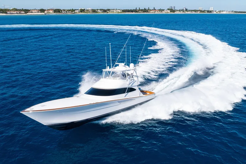 Slide: The Image of 2025 Viking 64 Convertible yacht cruising swiftly on open blue ocean waters. - 5