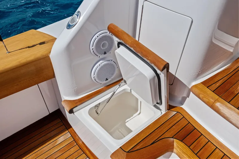 Slide: The Image of 2025 Viking 64 Convertible yacht deck with storage compartment and speakers. - 55