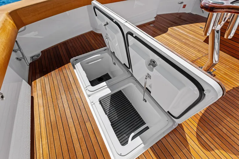 Slide: The Image of Open storage compartments on 2025 Viking 64 Convertible yacht with teak deck. - 57