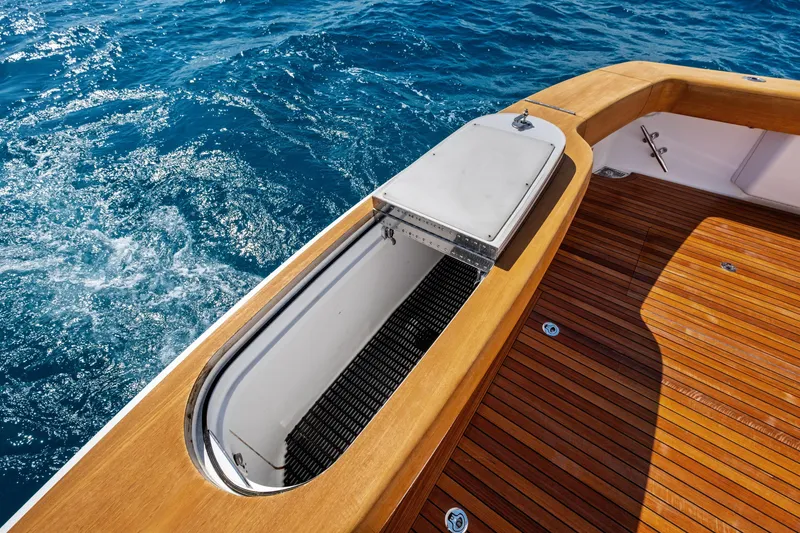 Slide: The Image of 2025 Viking 64 Convertible yacht deck with ocean view and wooden flooring. - 60