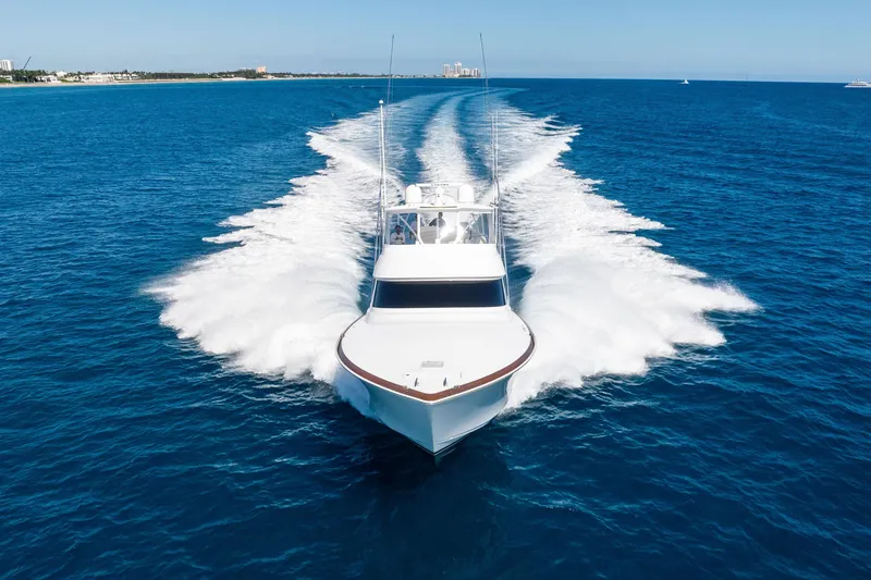 Slide: The Image of 2025 Viking 64 Convertible yacht cruising on open blue ocean waters. - 9
